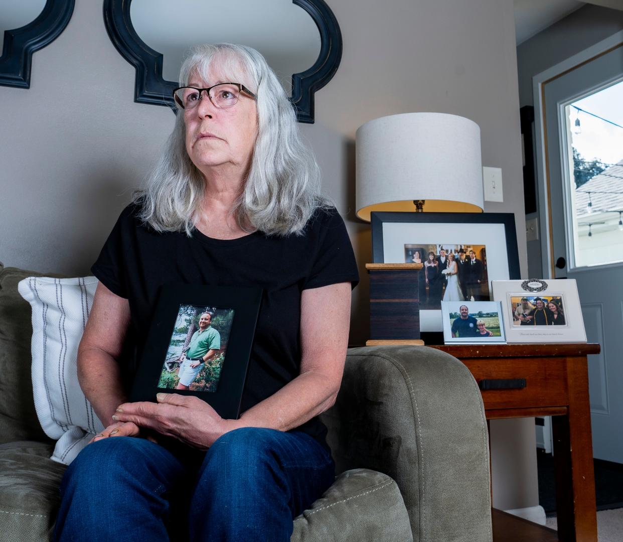 Deborah Hoffmann holds a photo of her ex-husband, Dean Hoffmann, on Sept. 9 in Cedarburg.