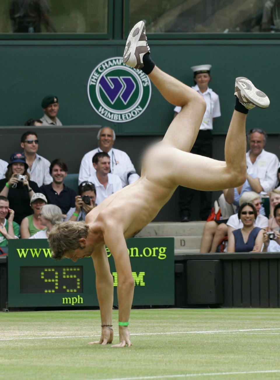 An unidentified streaker does a cartwheel, as he interrupts the Women's Singles quarter-final match between Maria Sharapova and Elena Dementieva, both of Russia, on the Centre Court at Wimbledon, in this July 4, 2006, file photo. (AP Photo/Anja Niedringhaus/FILE)