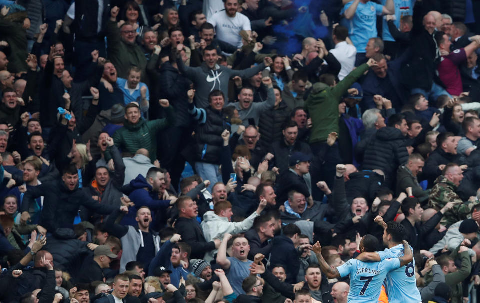 <p>Manchester City’s Ilkay Gundogan celebrates scoring their second goal with Raheem Sterling in front of fans </p>