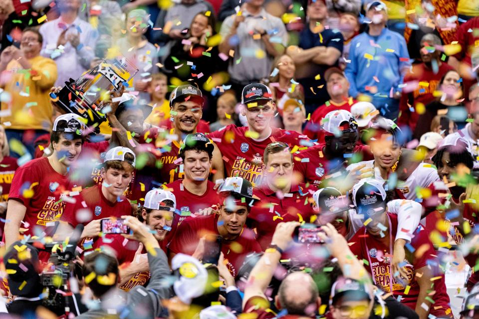 Confetti falls as Iowa State Cyclones players pose with Big 12 Tournament trophy after defeating the Houston Cougars at T-Mobile Center. ISU takes on Illinois in the Sweet 16 on Thursday.