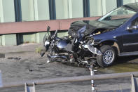 A car and a motorcycle stand on the city motorway A100 after an accident in Berlin, Germany, Wednesday, Aug. 19, 2020. The city's highway was still shut down after a series of traffic accidents that were allegedly all caused by one man. (Paul Zinken/dpa via AP)