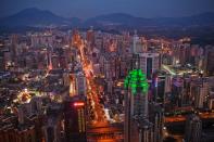 SHENZHEN, CHINA - NOVEMBER 28: The Shenzhen skyline, including The Shenzhen World Financial Center, illuminated by green lights, stretches in to the distance on November 28, 2010 in Shenzhen, China. According to the US Commercial Service, Shenzhen is one of the fastest growing cities in the world. Home of the Shenzhen Stock Exchange and the headquarters of numerous technology companies, the now bustling former fishing village is considered southern China's major financial centre. (Photo by Daniel Berehulak/Getty Images)