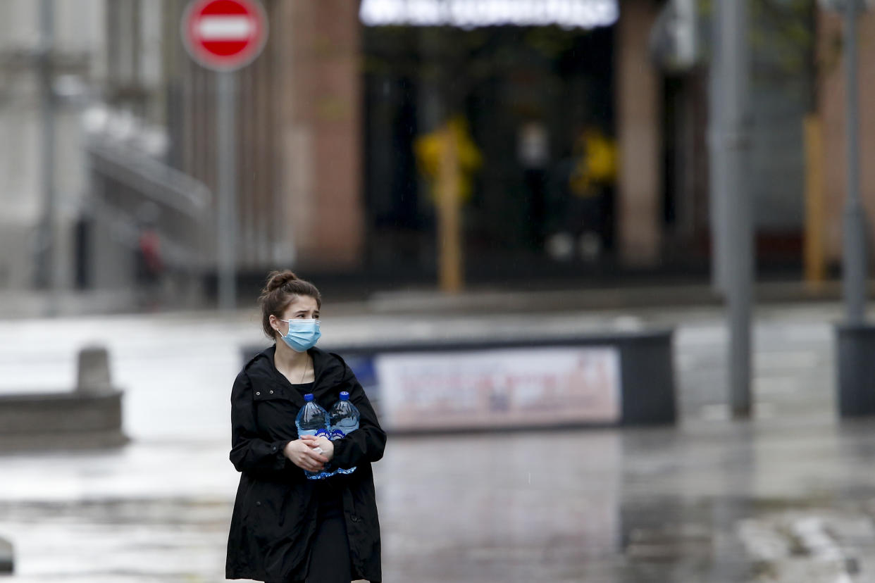 MOSCOW, RUSSIA - MAY 5: A woman wearing a mask walks at a Kamergerskiy Pereulok, remaning nearly empty due to the lockdown as a measure against the coronavirus (COVID-19) pandemic in Moscow, Russia on May 5, 2020. Russia on Tuesday confirmed 10,102 new cases of the novel coronavirus, bringing the total number to 155,370. he death toll in the country rose to 1,451, as 95 more people lost their lives over the past 24 hours, according to the Russian emergency team. The total number of recoveries reached 19,865, while 222,500 people remain under medical surveillance, it added. (Photo by Sefa Karacan/Anadolu Agency via Getty Images)