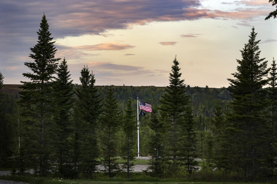 An U.S. flag flies at Patriot Park where a collection of monuments stand in tribute to veterans in Columbia Falls, Maine, Saturday, May 27, 2023. The Worcester family hopes to build a $1 billion world's tallest flagpole theme park nearby. (AP Photo/Robert F. Bukaty)