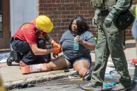 <p>People receive first-aid after a car accident ran into a crowd of protesters in Charlottesville, Va., on Aug. 12, 2017. (Photo: Paul J. Richards/AFP/Getty Images) </p>