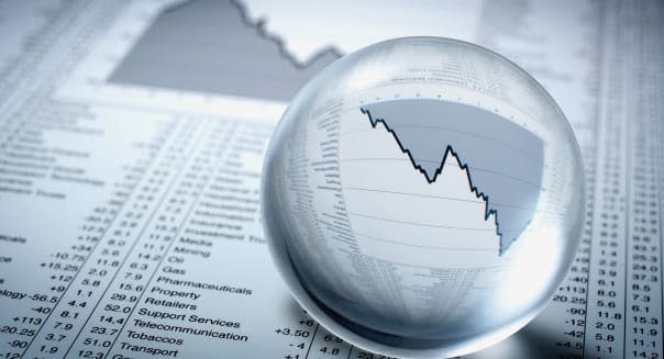 Crystal ball, descending line graph and share prices