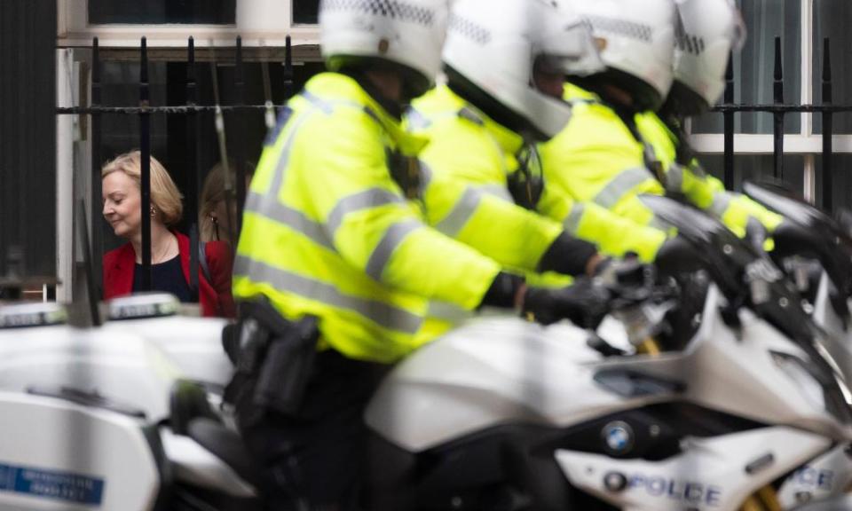 Police outriders wait to escort Truss from the back of Downing Street, 30 September 2022.