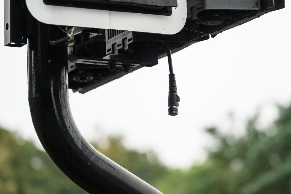 Damaged cabling hangs from a vandalised ULEZ enforcement camera after so-called 'bladerunners' it in protest to the expansion. (Getty)