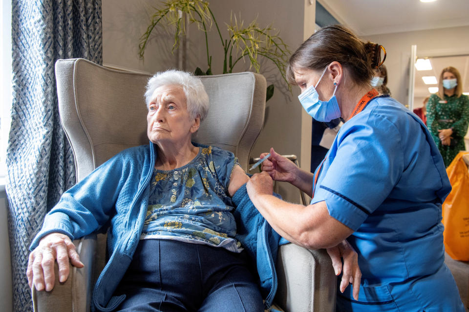 Registered Nurse Laura Hastings administers a COVID-19 vaccine booster to Agnes Taylor, 93, at Victoria Manor Care home, to launch the winter vaccine programme, in Edinburgh, Scotland, Britain September 5, 2022. Lesley Martin/Pool via REUTERS