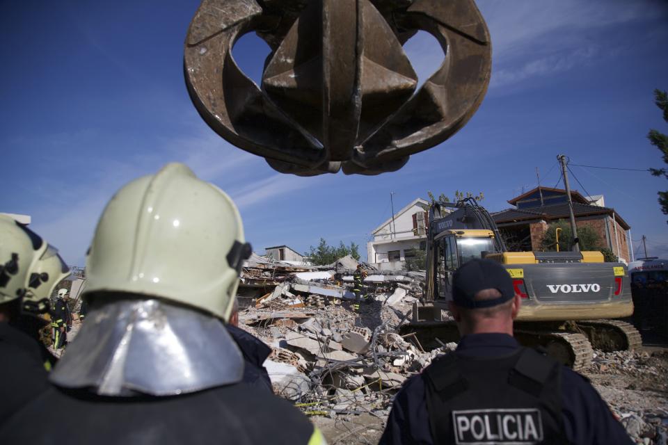 Rescuers search a damaged building in Durres, western Albania, Wednesday, Nov. 27, 2019. The death toll from a powerful earthquake in Albania has risen to 25 overnight as local and international rescue crews continue to search collapsed buildings for survivors. (AP Photo/Visar Kryeziu)