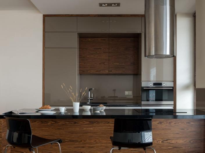 dark wood modern kitchen with black stools