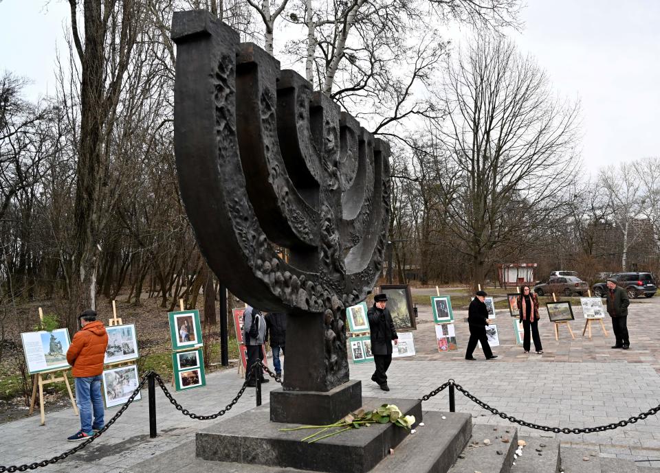 People gather near the Minora monument at Babi Yar (Babyn Yar), a place in Kiev where the Nazis shot more than 100,000 Jews between 1941 and 1943, for a memorial ceremony marking the International Holocaust Victims Remembrance Day on January 27, 2021. Holocaust remembrance groups around the world strongly condemned the damaging of the site.