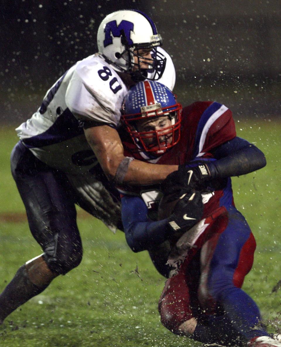 Muncie Central's Ryan Kerrigan (80) takes down Jay County's Michael Jobe.