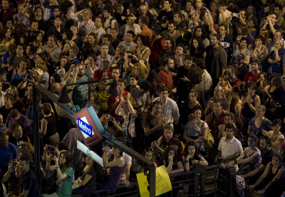 Protesters jam the metro station entrance during a protest in the Puerta del Sol plaza in central Madrid Saturday May 12, 2012. The protesters returned to Sol to mark the anniversary of the protest movement that inspired groups in other countries. The protests began May 15 last year and drew hundreds and thousands of people calling themselves the indignant movement. The demonstrations spread across Spain and Europe as anti-austerity sentiment grew. (AP Photo/Paul White)