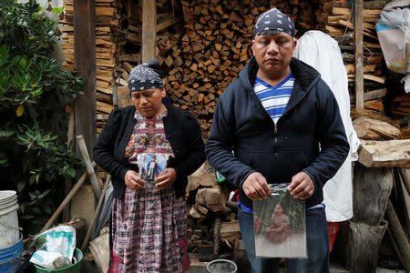 Gilberto Gomez and Lidia Gonzalez hold pictures of their daughter Claudia Gomez, a 19-year old Guatemalan immigrant who was shot by an U.S. Border Patrol officer, at their home in San Juan Ostuncalco, Guatemala May 27, 2018. REUTERS/Luis Echeverria