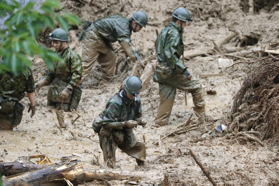 Japan Ground Self-Defense Force search missing persons at the site of a mudslide in Tsunagi town, Kumamoto prefecture, southwestern Japan, Tuesday, July 7, 2020. Floodwaters flowed down streets in southwestern Japanese towns hit by deadly rains that were expanding across the region Tuesday. (Kyodo News via AP)