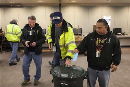 Union members cast their ballots at the International Association of Machinists District 751 Headquarters during a union vote in Seattle, Washington by the association's members on a proposed contract by the Boeing Company to build the 777X jetliner November 13, 2013. REUTERS/David Ryder