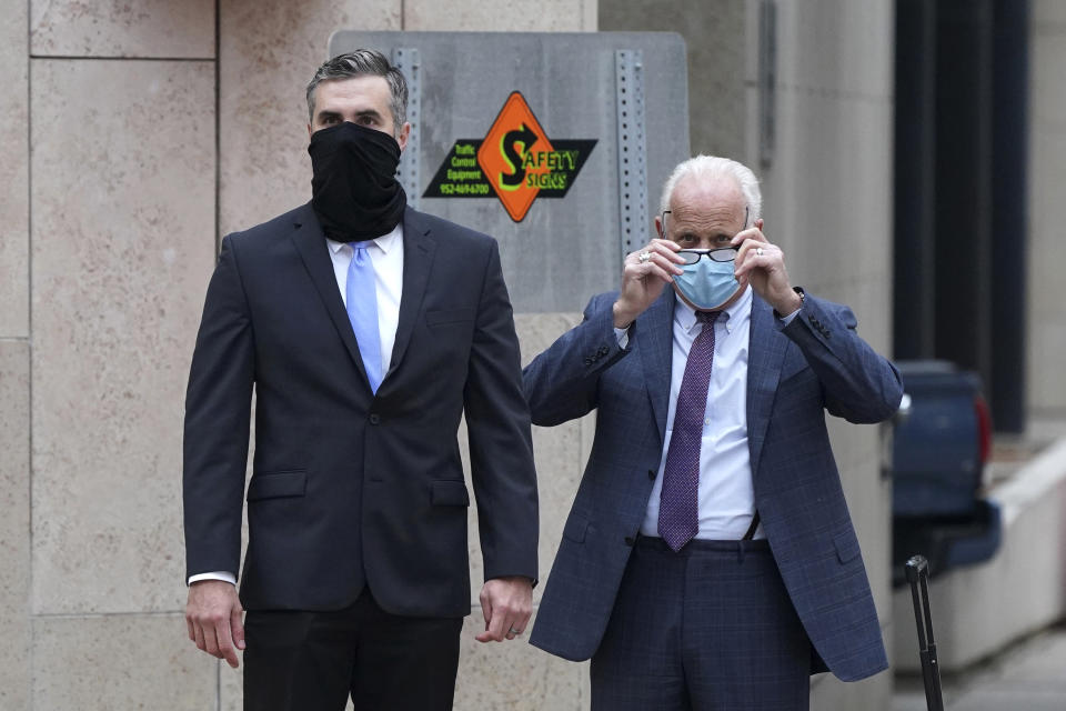 FILE - Former Minneapolis police officer Thomas Lane, left, arrives with his attorney Earl Gray at the Hennepin County Family Justice Center Friday, Sept. 11, 2020, for a hearing in the cases against the four former police officers charged in the death of George Floyd, in Minneapolis. The federal judge who sentenced Lane to 2 1/2 years in prison on a civil rights charge in the killing of George Floyd says Lane won't have to surrender until after his sentencing in a separate case in two months. Legal experts say that's not unusual, even in an emotionally charged case like this. (Anthony Souffle/Star Tribune via AP, File)