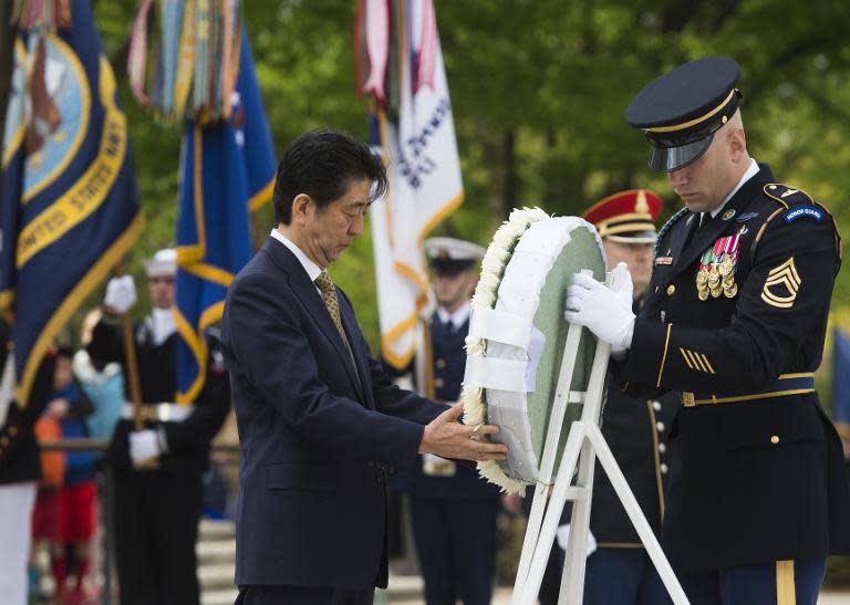 Japanese Prime Minister Shinzo Abe participates in a wreath laying ceremony at the Tomb of the Unknown Soldier at Arlington National Cemetery on April 27, 2015