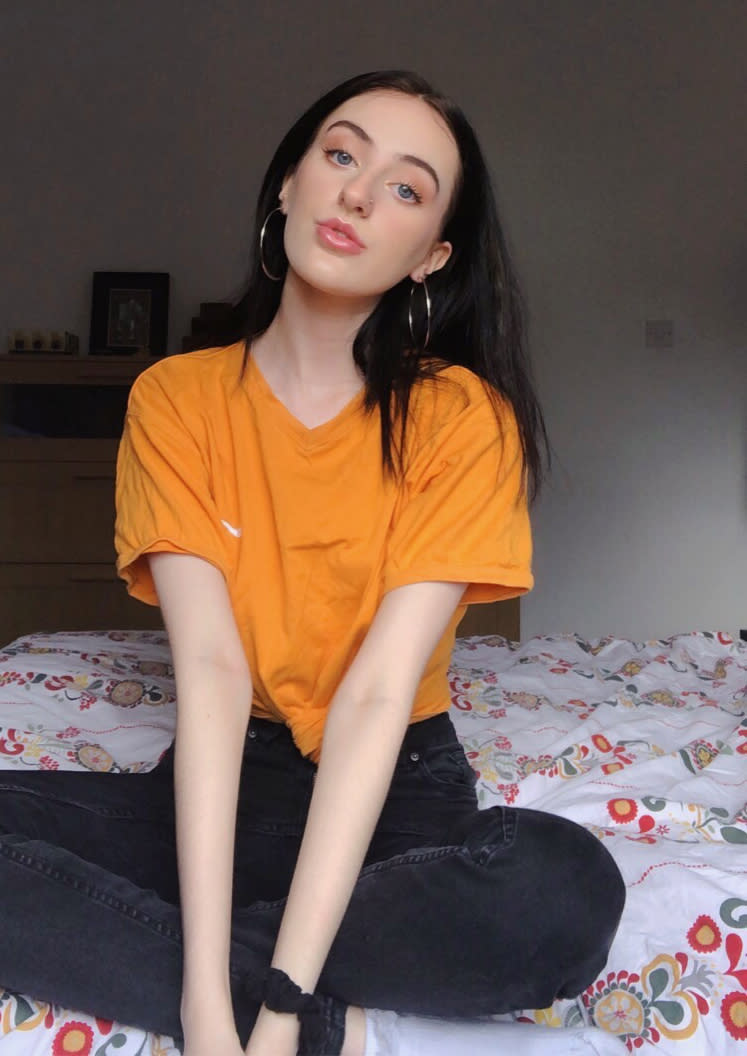 Holly HopkinsUK teen sits on bed after celebrating body positivity for big noses