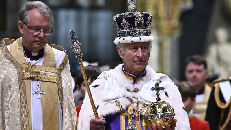 Britain’s King Charles III, wearing the Imperial state Crown and carrying the Sovereign’s Orb and Sceptre, leaves Westminster Abbey after coronation in central London Saturday, May 6, 2023. The set-piece coronation is the first in Britain in 70 years, and only the second in history to be televised. 