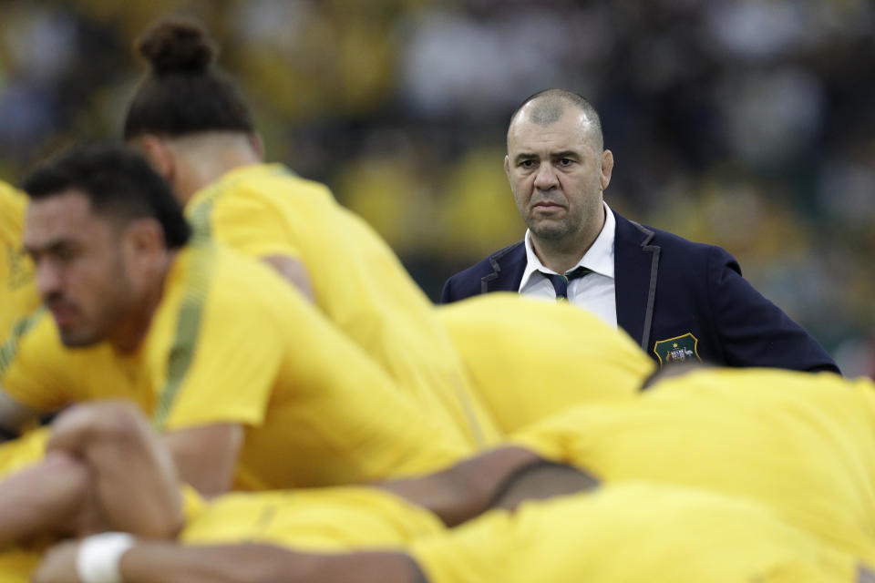 Australia coach Michael Cheika watches as his team warm up before the Rugby World Cup quarterfinal match at Oita Stadium between England and Australia in Oita, Japan, Saturday, Oct. 19, 2019. (AP Photo/Aaron Favila)