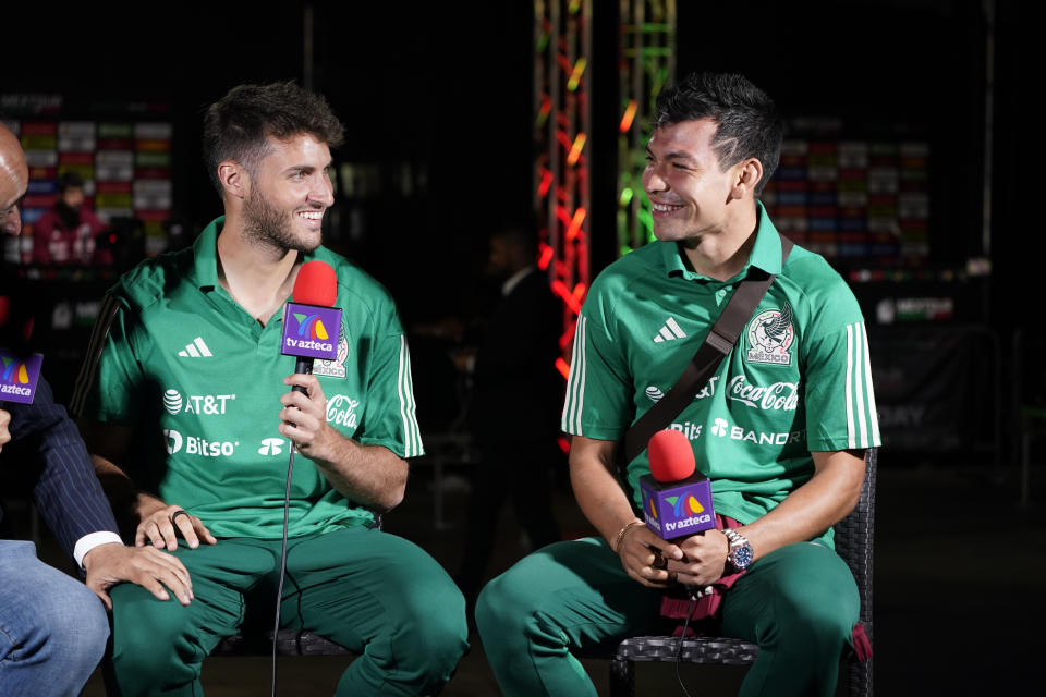 Mexico's Santiago Jimenez, and Hirving Lozano conduct and interview during the soccer team's Media Day ahead of the 2022 FIFA World Cup in Qatar Tuesday, Sept. 20, 2022, in Carson , Calif. (AP Photo/Marcio Jose Sanchez)