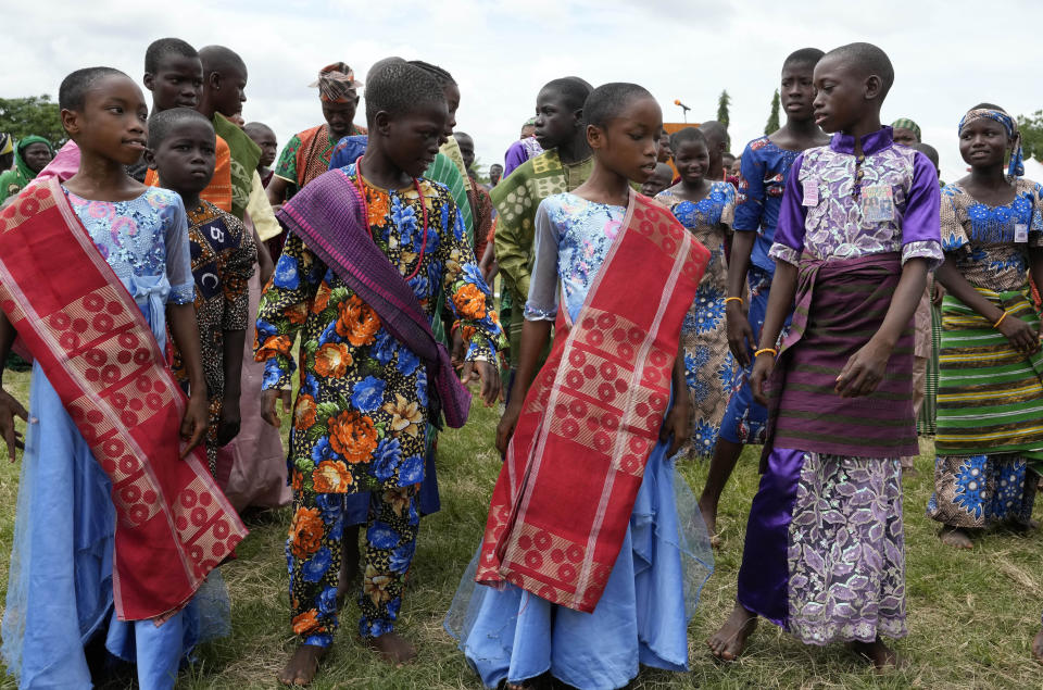 Twins wait to perform during the annual twins festival in Igbo-Ora South west Nigeria, Saturday, Oct. 8, 2022. The town holds the annual festival to celebrate the high number of twins and multiple births. (AP Photo/Sunday Alamba)