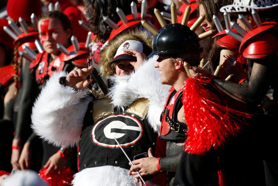 Georgia fans root on their team during the first half of a NCAA college football game between Charleston Southern and Georgia in Athens, Ga., on Saturday, Nov. 20, 2021. Georgia won 56-7.