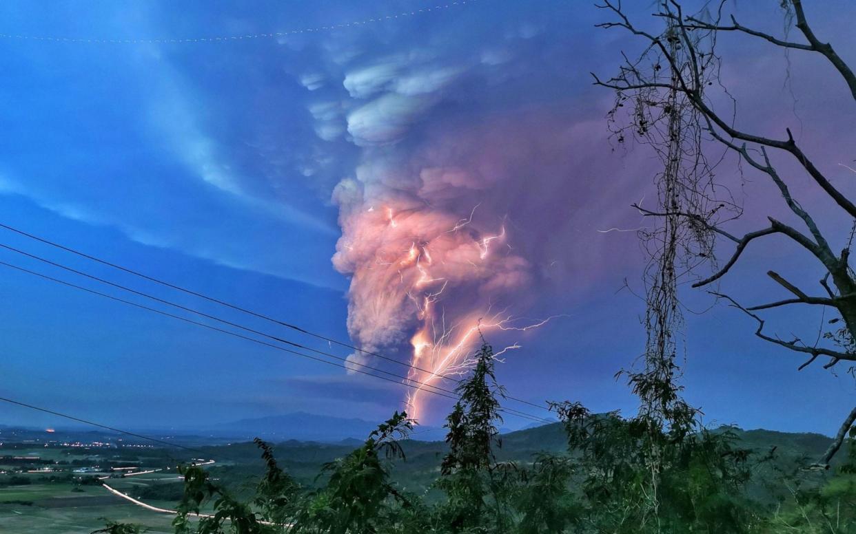 Lightning streak over Batangas as Taal Volcano continues its eruption on Sunday evening. - https://www.alamy.com