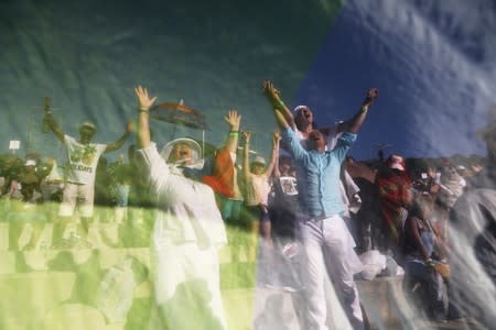 Christian pilgrims and tourists are seen through the fabric as they react during a religious retreat lead by T.B. Joshua, a Nigerian evangelical preacher on Mount Precipice, Nazareth