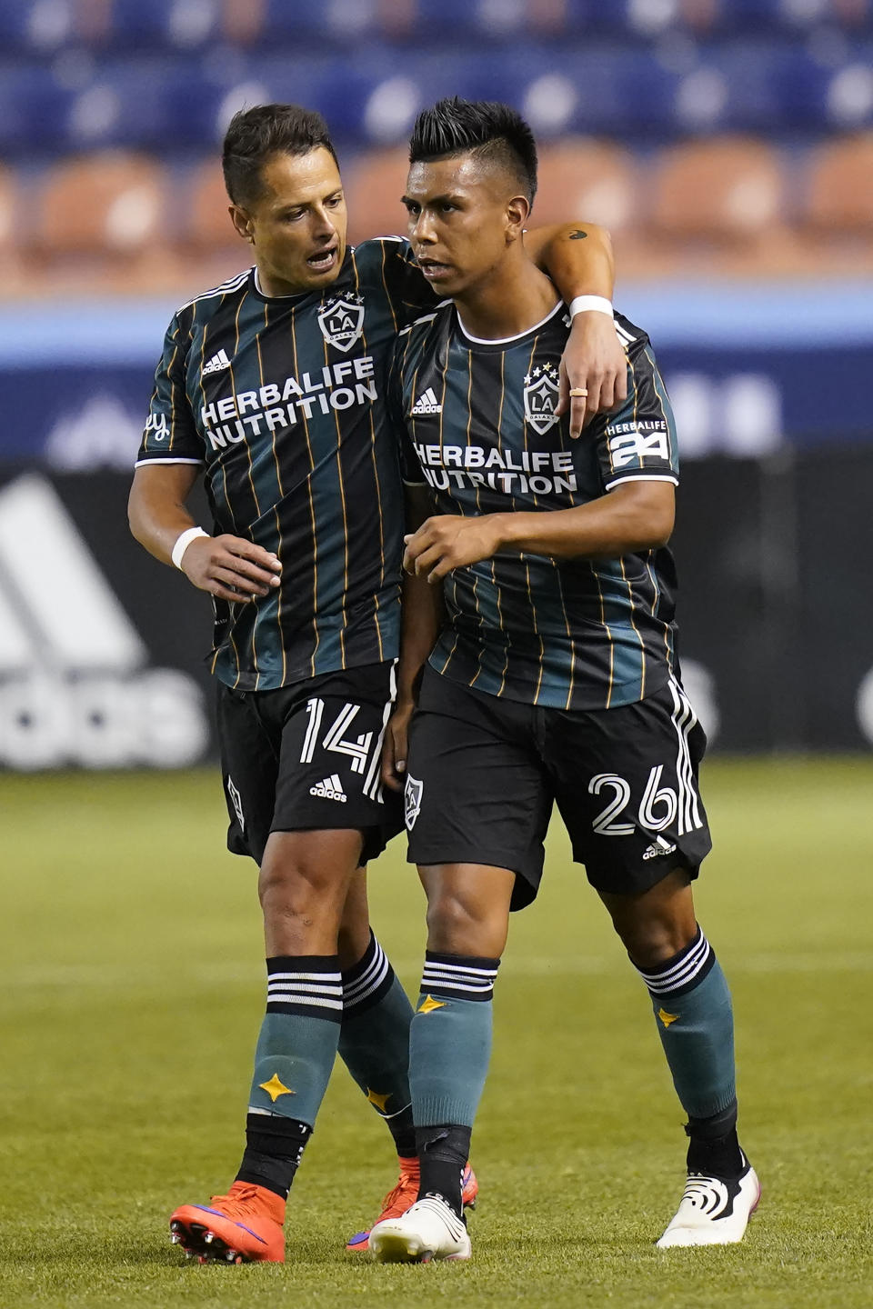 Los Angeles Galaxy's Efrain Alvarez (26) celebrates with Chichartio (14) after scoring against the Vancouver Whitecaps in the second half during an MLS soccer match Wednesday, June 23, 2021, in Sandy, Utah. (AP Photo/Rick Bowmer)