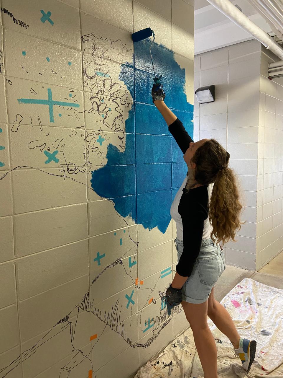 Sarah Painter Hayes works on the mural at Sabal Palm Elementary, which was unveiled on Aug. 2, 2023.