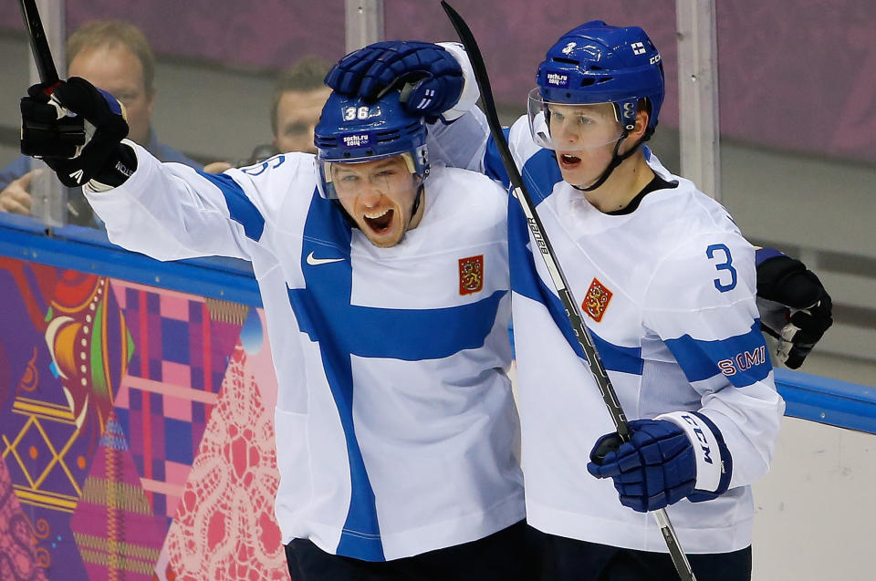 Jussi Jokinen of Finland (36) congratulates Olli Maatta (3) on his goal against the United States during the third period of the men's bronze medal ice hockey game at the 2014 Winter Olympics, Saturday, Feb. 22, 2014, in Sochi, Russia. (AP Photo/Matt Slocum)