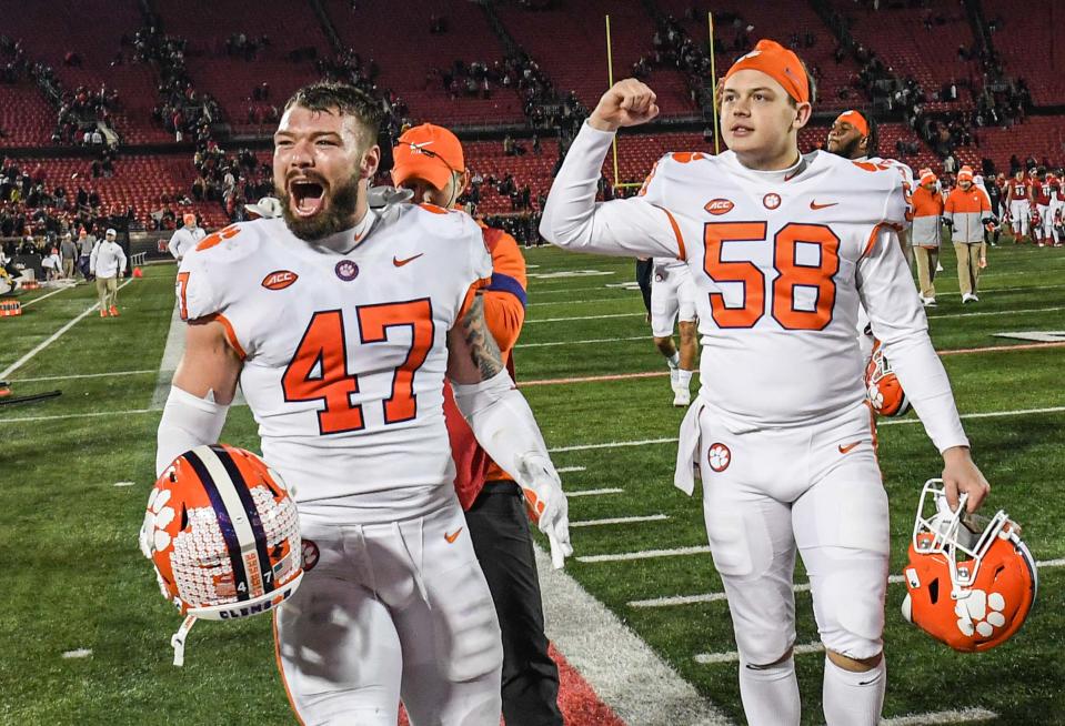 Clemson linebacker James Skalski(47) celebrates with teammate longsnapper Holden Caspersen (58)during the fourth quarter at Cardinal Stadium in Louisville, Kentucky Saturday, November 6, 2021.