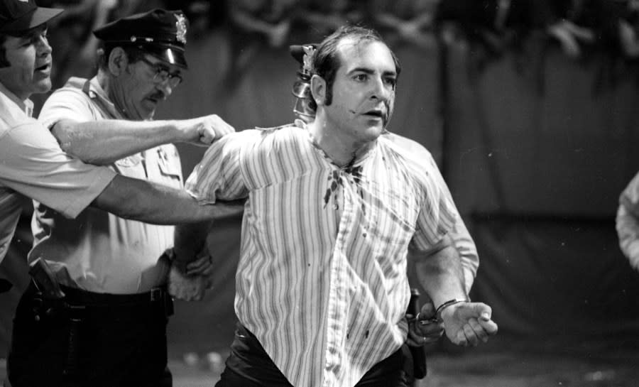 CLEVELAND, OH – JUNE 4,1974: A drunken fan is helped off the field after sufering a minor injury during a game between the Texas Rangers and Cleveland Indians on June 4, 1974 at Cleveland Municipal Stadium in Cleveland, Ohio. Texas was awarded a win by forfeit 5-5 when the game was called by the umpires, due to fans storming the field during 10 cent beer night. (Photo by: Paul Tepley Collection/Diamond Images/Getty Images)