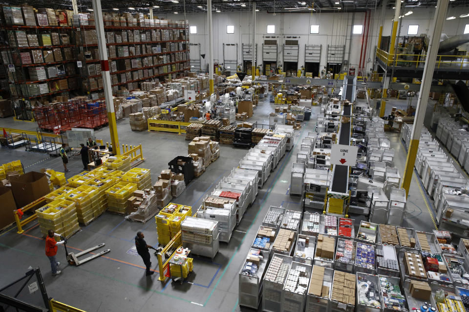 FILE- In this Aug. 3, 2017, file photo, workers prepare to move products at an Amazon fulfillment center in Baltimore. Amazon will spend more than $700 million to provide additional training to about one-third of its U.S. workforce. (AP Photo/Patrick Semansky, File)