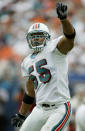 Miami Dolphins' linebacker Junior Seau celebrates after bringing down the Houston Texans' running back Stacey Mack for a loss during their NFL season-opener September 7, 2003 in Miami. Seau came to the Dolphins from the San Diego Chargers. REUTERS/Marc Serota