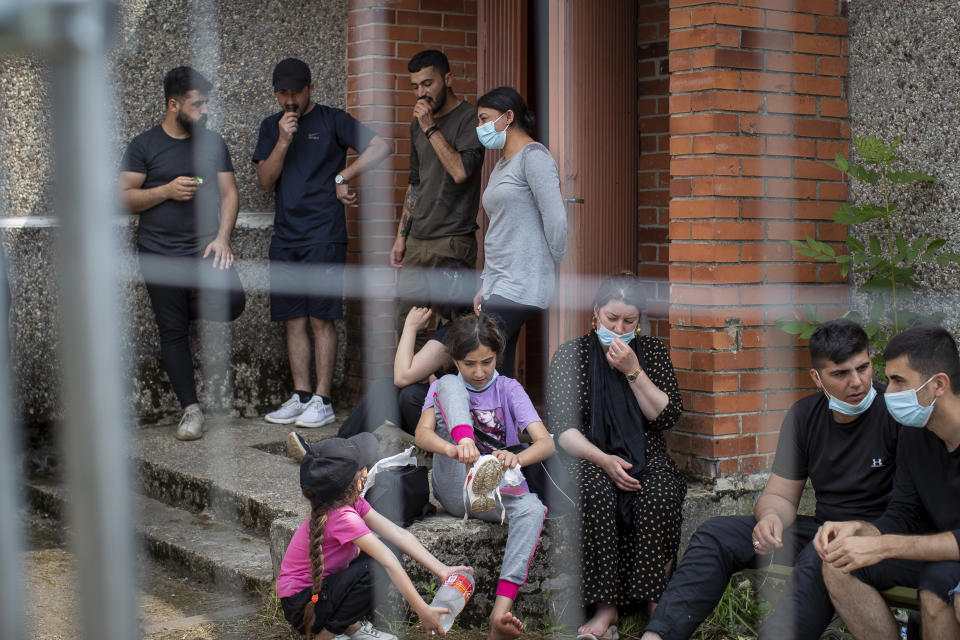 Migrants from Iraq rest at the refugee camp in the village of Verebiejai, some 145km (99,1 miles) south from Vilnius, Lithuania, Sunday, July 11, 2021. Migrants at the school in the village of Verebiejai, about 140 kilometers (87 miles) from Vilnius, haven't been allowed to leave the premises and are under close police surveillance. Some have tested positive for COVID-19 and have been isolated in the building. (AP Photo/Mindaugas Kulbis)