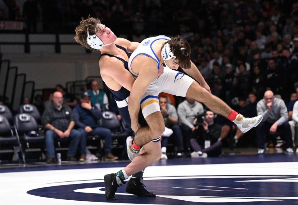 Penn State’s David Evans lifts Hofstra’s Alex Turley (141 lbs) off the mat enroute to a takedown during Sunday’s match at Rec Hall at University Park. Evans defeated Turley by tech fall, 19-4. Penn State defeated Hofstra, 43-10.