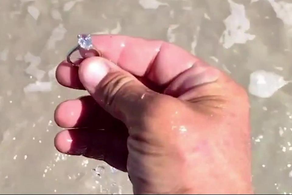 Video grab of metal detector Joseph Cook finding a $40,000 diamond ring on Hammock Beach in St Augustine, St Johns County, Florida, USA