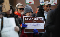 A protester holds a placard at a rally of advocates to voice opposition to efforts by the Trump administration to weaken the National Environmental Policy Act, which is the country's basic charter for protection of the outdoors on Tuesday, Feb. 11, 2020, in Denver. (AP Photo/David Zalubowski)