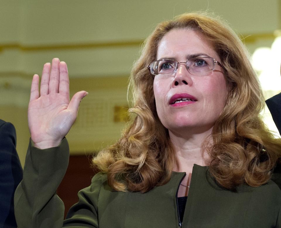 Katherine Mitchell, a physician with the Department of Veterans Affairs in Phoenix, is sworn-in to testify before a House VA Committee hearing on July 8, 2014, about inadequate health care. Mitchell says she was harassed and humiliated after complaining about problems at the hospital, where dozens of veterans died while on waiting lists for appointments.