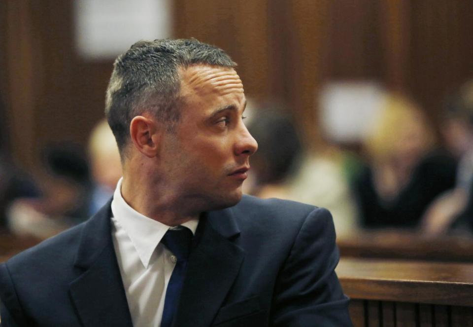 Oscar Pistorius looks back in a courtroom at the high court in Pretoria, South Africa, Tuesday, May 6, 2014. A man who lives next to the house where Pistorius fatally shot his girlfriend has testified at the athlete's murder trial about the night of the killing, saying he heard a man crying loudly and that he called the security of the housing estate for help. (AP Photo/Mike Hutchings, Pool)