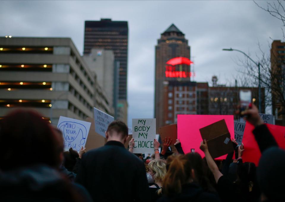 Protesters chant and hold signs in opposition of the United States Supreme Court's document outlining the repeal of Roe v. Wade during the Abort the State rally and march in downtown Des Moines on Wednesday, May 4 2022.