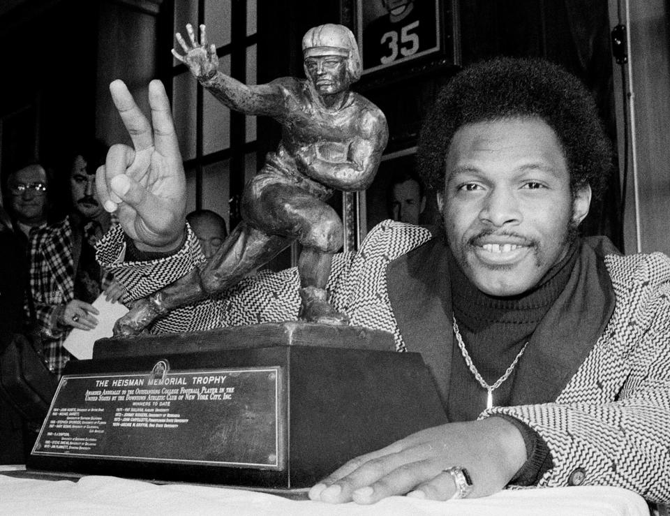 b&w - ** FILE ** Ohio State's running back Archie Griffin smiles as he poses with the 1975 Heisman Trophy, on Dec. 2, 1975, in New York City. Griffin who also won in 1974, is the first player to win the prestigious award twice. Griffin wouldn't mind sharing his claim to fame. The former Ohio State tailback is the only player to win two Heisman trophies, receiving his second in 1975. Oklahoma quarterback Jason White has a chance to match Griffin on Saturday when the Heisman is handed out in New York.  (AP Photo)