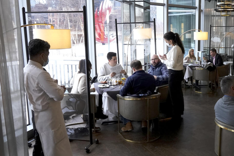 FILE - In this Jan. 27, 2021 file photo, patrons enjoy lunch indoors at Gibsons Italia restaurant in Chicago. A recent spike in coronavirus cases in some states has led one of the nation's top health experts to suggest that governors could “close things down” like they did during previous surges. But that doesn't appear likely to happen — not even in states led by Democratic governors who favored greater restrictions in the past. (AP Photo/Charles Rex Arbogast, File)