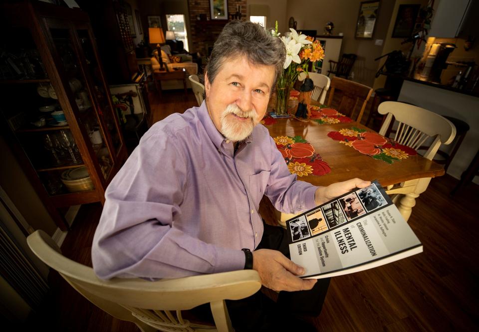 Risdon Slate is a criminology professor at Florida Southern, has written a textbook--The Criminalization of Mental Illness--and is an expert in the field. He has testified before Congress and conducts law enforcement training for dealing with those with mental illness. He is also bipolar. Photographed  at his home in Lakeland, Fla., Wednesday, November 17, 2021. ERNST PETERS/ THE LEDGER