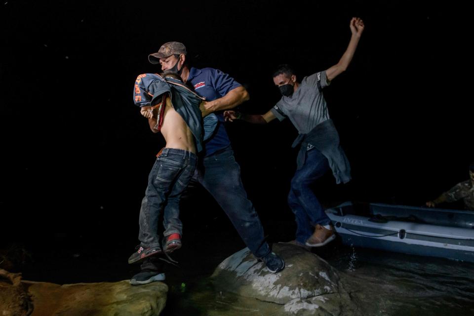 March 29, 2021: Migrants from Central America crossing illegally from Mexico to the US to seek asylum disembark from an inflatable boat on the US side of the Rio Grande river at the border city of Roma on March 29, 2021. (Photo by Ed JONES / AFP) (Photo by ED JONES/AFP via Getty Images) ORG XMIT: 0 ORIG FILE ID: AFP_97222Q.jpg