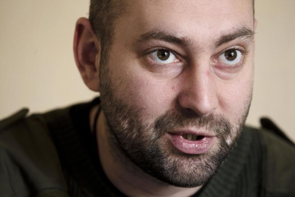 In this photo taken Friday, March 7, 2014, Andriy Tarasenko, a spokesman for the Right Sector, speaks during an interview with The Associated Press at the Dnipro hotel near the Independence Square, Kiev, Ukraine. The vocal and well-armed organization presents a headache for the new Ukrainian leadership with its armed presence in the streets, its radical nationalist rhetoric and its antics. “We are Ukrainian nationalists. A nationalist is a person who is ready to sacrifice their time, their freedom and even their life for the sake of Ukraine and Ukrainians,” Tarasenko, a top member of the group told the Associated Press in an interview. “If Ukraine is not for Ukrainians, then who is it for?” (AP Photo/David Azia)